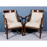 A pair of 19th century French Empire mahogany armchairs, the curved square backs with carved dolphin