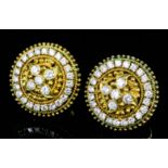 A pair of modern gold coloured metal mounted all diamond set target pattern earrings (for pierced