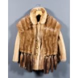 A lady's blonde mink single breasted jacket with three-quarter length sleeves and belt to back,