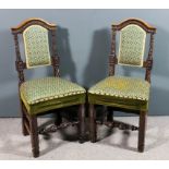 A pair of Victorian walnut occasional chairs, the arched crest rails carved with leaf ornament, on