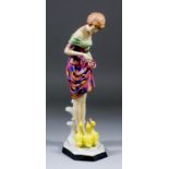 A Royal Dux pottery figure of a young woman feeding three ducklings, signed "Kwasnitschka", (circa