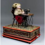 A late 19th/early 20th Century German automaton of a seated girl at a treadle sewing machine, the