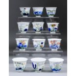 A set of twelve Chinese porcelain month cups enamelled in colours with various flowers and branches,