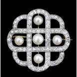 A 1920's silvery coloured metal mounted diamond and pearl set circular pattern brooch, set with five