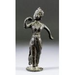 An Indian bronze standing figure of a dancing female deity, her head turned facing her raised