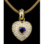A modern 18ct gold mounted sapphire and diamond set heart pattern pendant, set to the centre with
