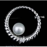 A modern 18k white gold pearl and diamond set circlet pattern brooch, the reeded border with a small