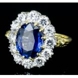 A modern 18ct gold mounted sapphire and diamond ring, the oval cut sapphire of approximately 2.7ct