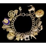 A modern 9ct gold curb link bracelet hung with twenty four charms, 185mm overall, and 9ct gold