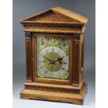 A late Victorian oak cased mantel clock, the 9ins brass dial with silvered chapter ring with Roman