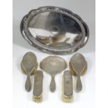 A French silvery metal oval dressing table tray with leaf cast rim and part reeded rim, 14ins x 10.