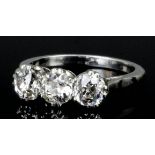 A silvery coloured mounted diamond three stone ring, the brilliant cut stones each approximately .