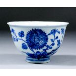 A Japanese blue and white porcelain tea bowl painted with flowering branches and insects, 4ins (10.