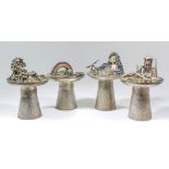 A set of four Elizabeth II silver and enamel table candlesticks (matched with mythical table