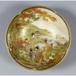 A Japanese Satsuma circular dish decorated in gilt and enamelled in colours with figures in a