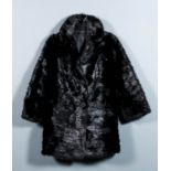 A lady's black musquash jacket with three-quarter length sleeves, lined, size 10-12, 33ins long