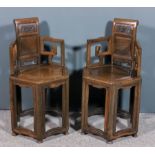 A pair of Chinese Jichimu (chicken feather) wood hexagonal armchairs with scroll cresting, fretted