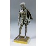 A late 19th Century French bronze figure of a young man in Elizabethan dress and with a sword in his