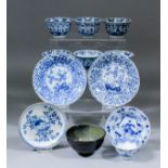 Six Chinese blue and white porcelain tea bowls, all variously painted with flowers in shaped panels,