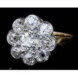 A modern gold coloured metal mounted diamond flowerhead pattern ring, central brilliant cut stone of