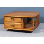 A modern Ercol elm rectangular two tier occasional table, fitted two drawers to one side, on