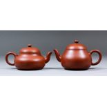 Two Chinese Yixing red stoneware miniature teapots with squat circular bodies, the domed covers with