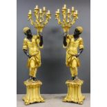 A pair of Continental carved, painted and gilt Blackamoor electroliers in the form of a standing