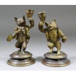 A pair of 19th Century Continental brass candlesticks modelled anthropomorphically as a standing