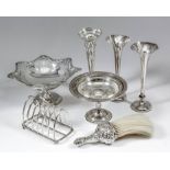 A George V silver rectangular six division toast rack of pointed arch form, with conforming loop