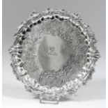 A George II silver circular waiter with shaped and moulded rim cast with leaf and scroll ornament,