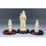 A Japanese carved ivory Okimono of a standing bearded sage, his left hand raised to his beard,