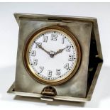 A George V silver cased travelling timepiece, the 2.25ins white enamel dial with Arabic numerals, to