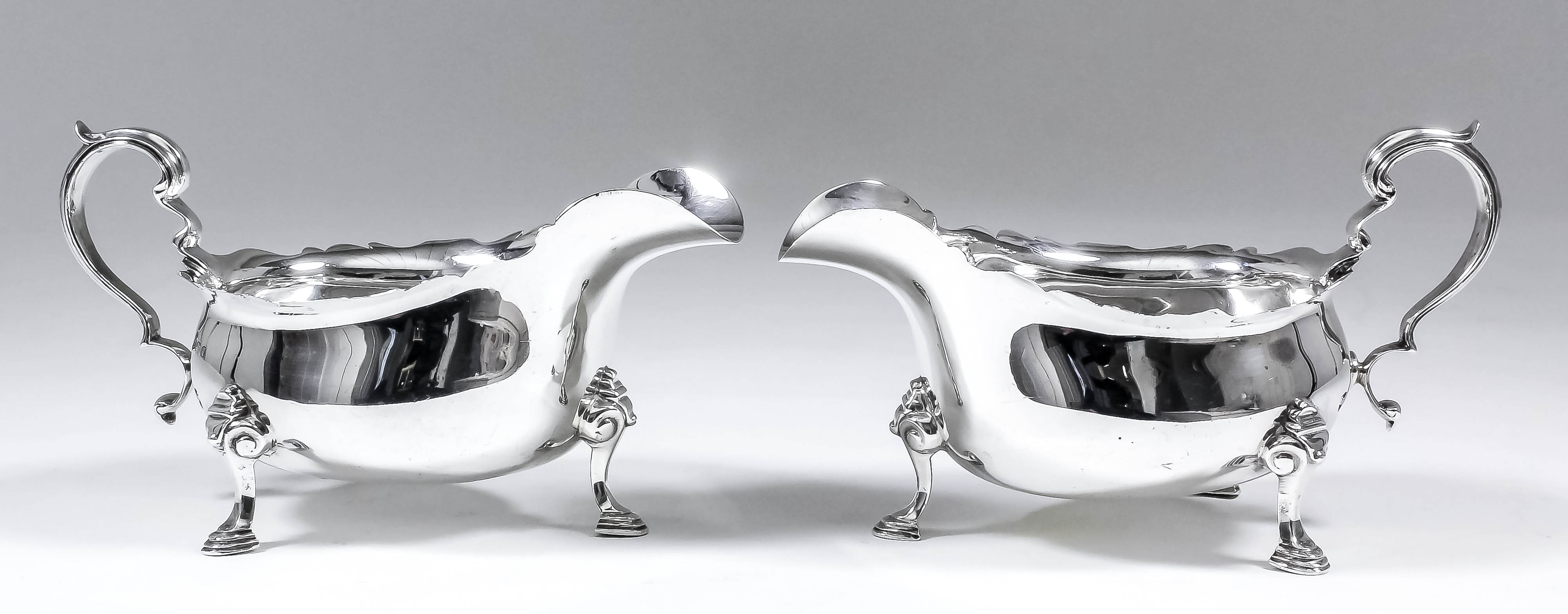 A pair of George V silver James pattern sauce boats with scroll moulded rims and on scroll feet, 3.
