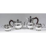 A George VI silver four piece tea service of spherical form, the rims cast with band of Celtic