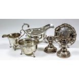 A George V silver sauce boat with gadroon mounts, leaf capped double C-scroll handle, on hoof