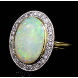 A modern 18ct gold mounted opal and diamond ring, the oval cut opal of approximately 4.50ct