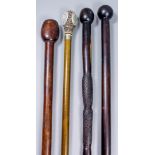 A 20th Century African hardwood walking cane with incised chevron decoration to the shaft and ball-