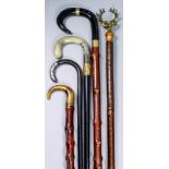 A late 19th/early 20th Century ebony walking stick with gilt copper collar and horn handle, 35ins,