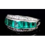 A 1950's silvery coloured metal mounted emerald and diamond half hoop eternity ring, the face set