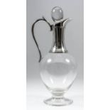 An Elizabeth II silver mounted and Dartington glass claret jug with scroll handle, on circular