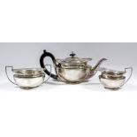 An Edward VII silver circular three piece tea service of bulbous squat form, comprising - teapot