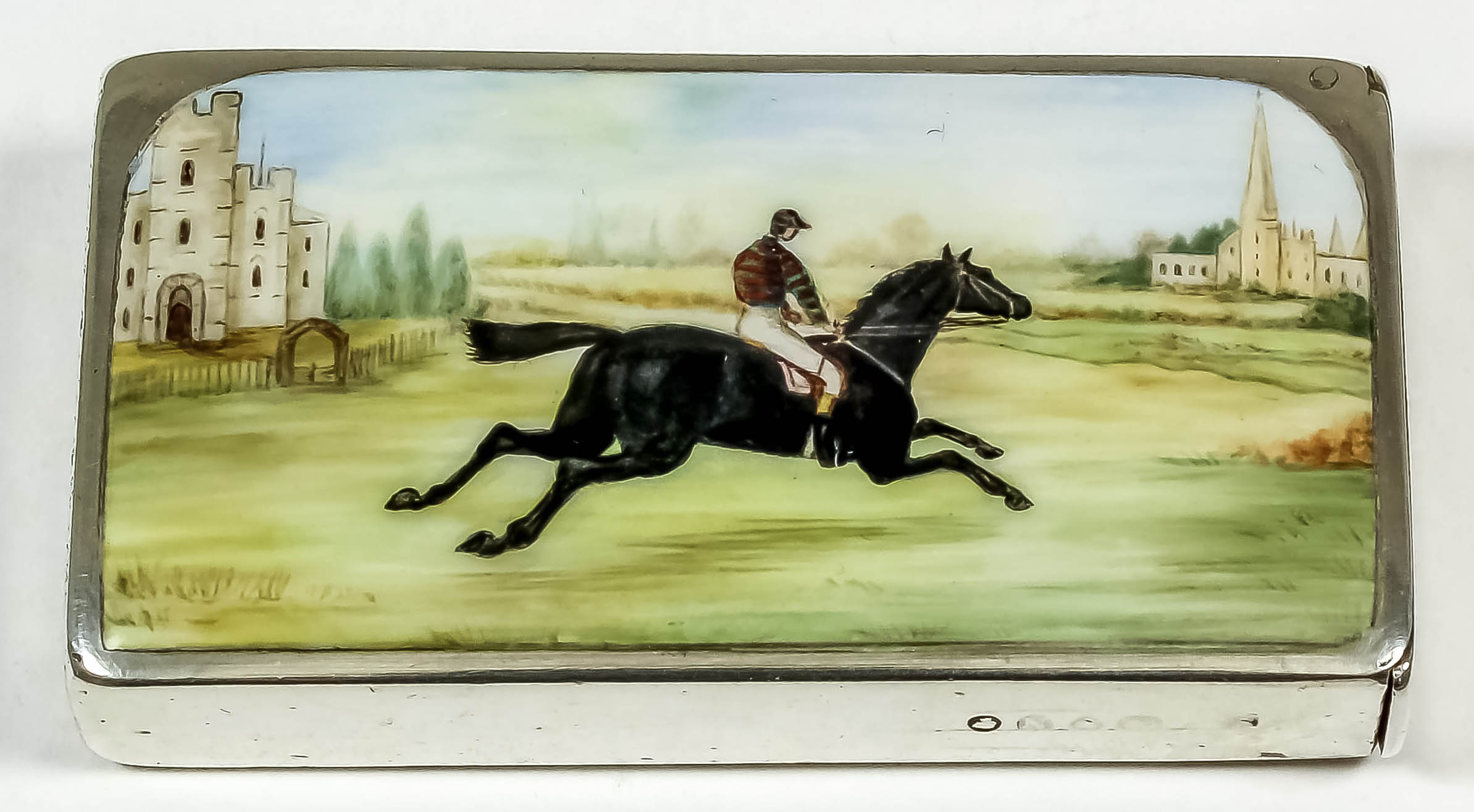 A Victorian silver rectangular vesta case, the front enamelled in colours with a race horse and