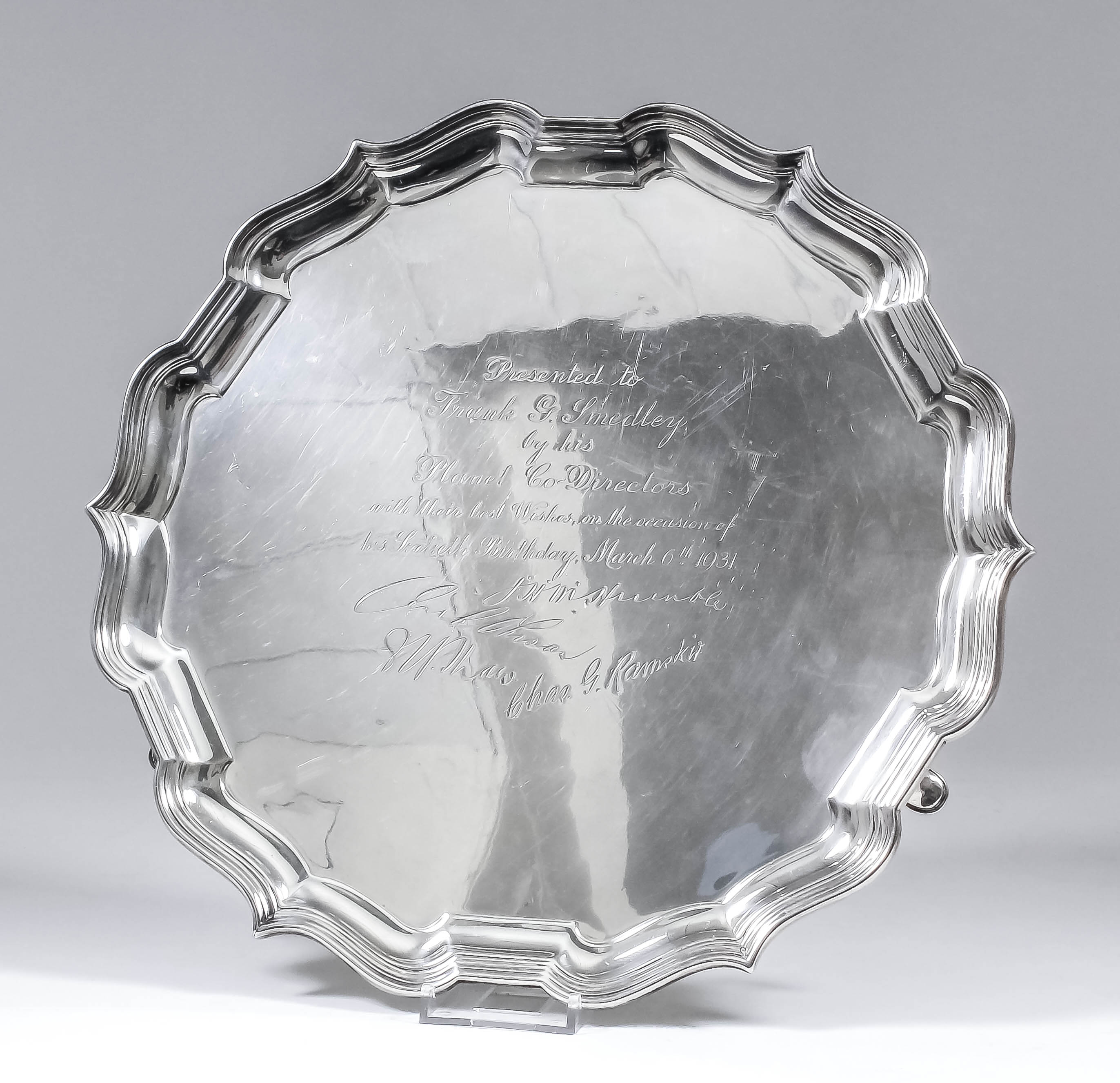 An Edward VII silver salver of shaped and moulded outline, on three scroll supports, 12.5ins