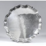 An Edward VII silver salver of shaped and moulded outline, on three scroll supports, 12.5ins