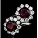 A modern 15ct white gold mounted rubelite and diamond twin pattern flowerhead ring, the circular cut