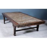 A Chinese hardwood rectangular day bed with plate glass top (for use as a coffee table), on four