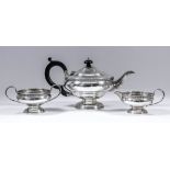 A George V silver circular three piece tea service of bulbous squat form, with egg and dart