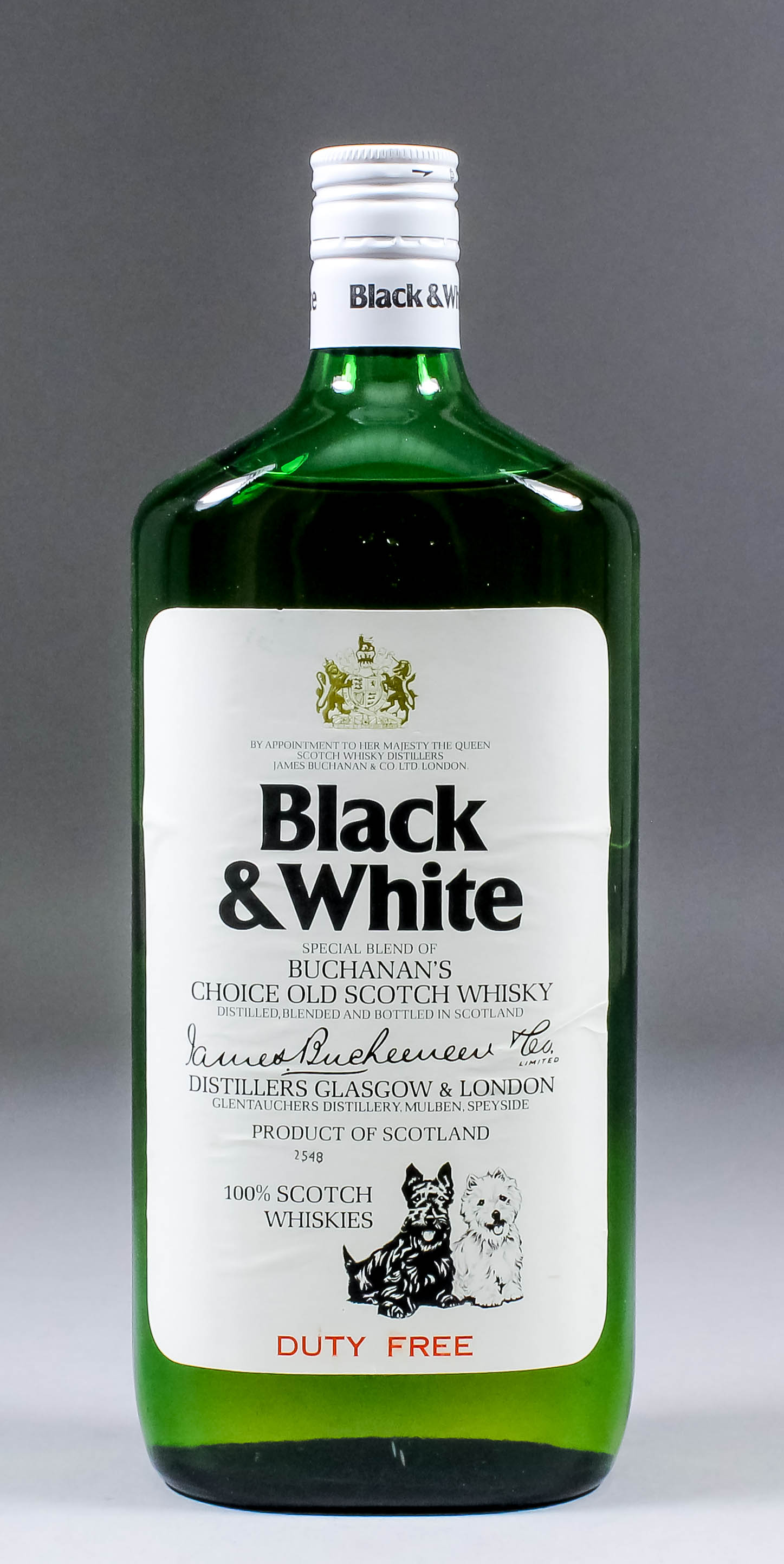 A bottle of Black and White Scotch whisky by Buchanans (circa 1955 - unopened) in green bottle