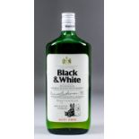 A bottle of Black and White Scotch whisky by Buchanans (circa 1955 - unopened) in green bottle
