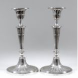 A pair of Edward VII silver oval pillar candlesticks of Neo-Classical fluted form, with urn